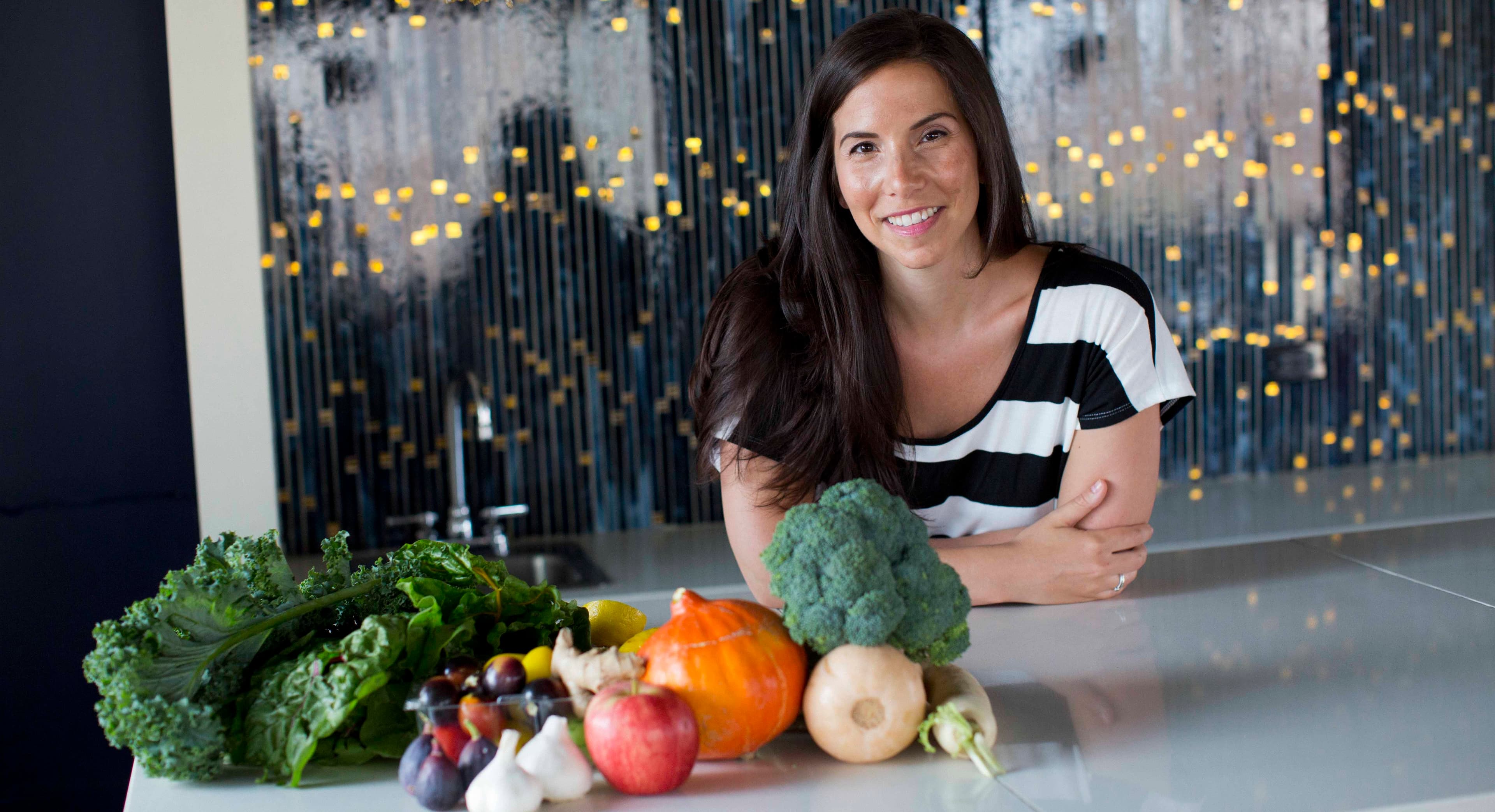 Jennifer Leigh in her kitchen with fresh vegetables